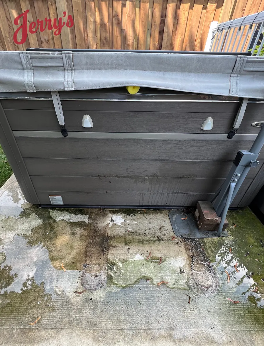 Before: Concrete pad under a hot tub covered in green algae and dirt